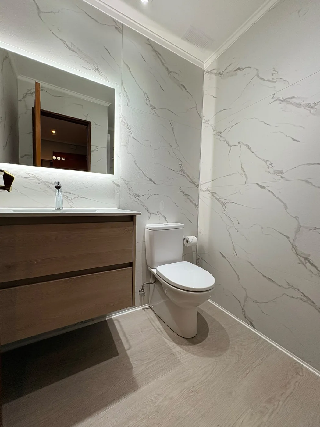 Baño reformado en Deusto, zona de lavabo con revestimiento tipo mármol